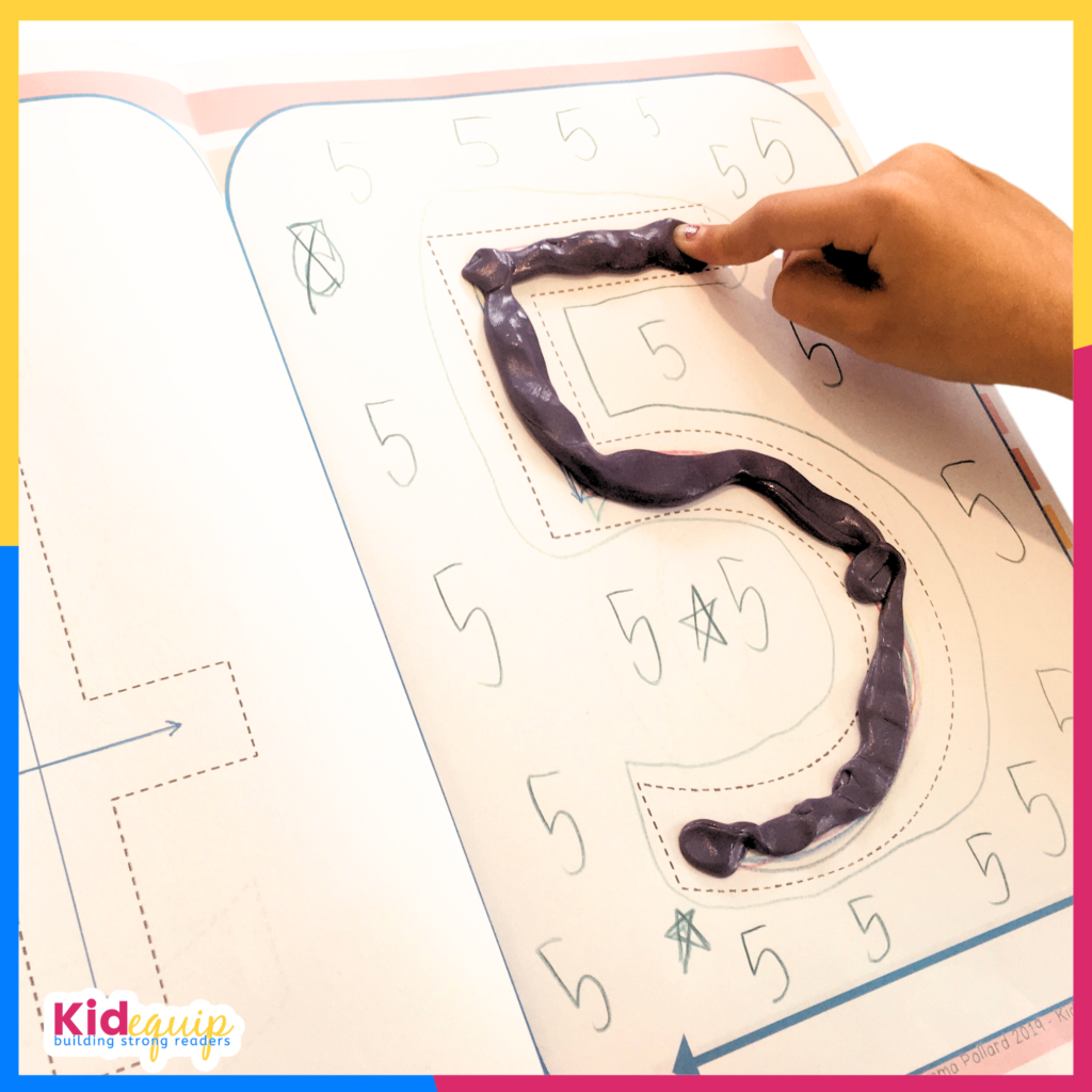 A child tracing the number 5 with their finger for multi sensory input